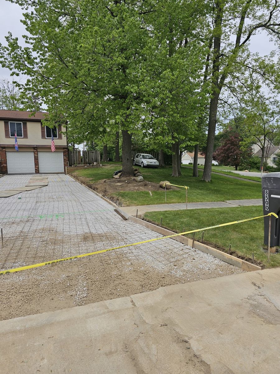 New concrete driveway leading to a garage
